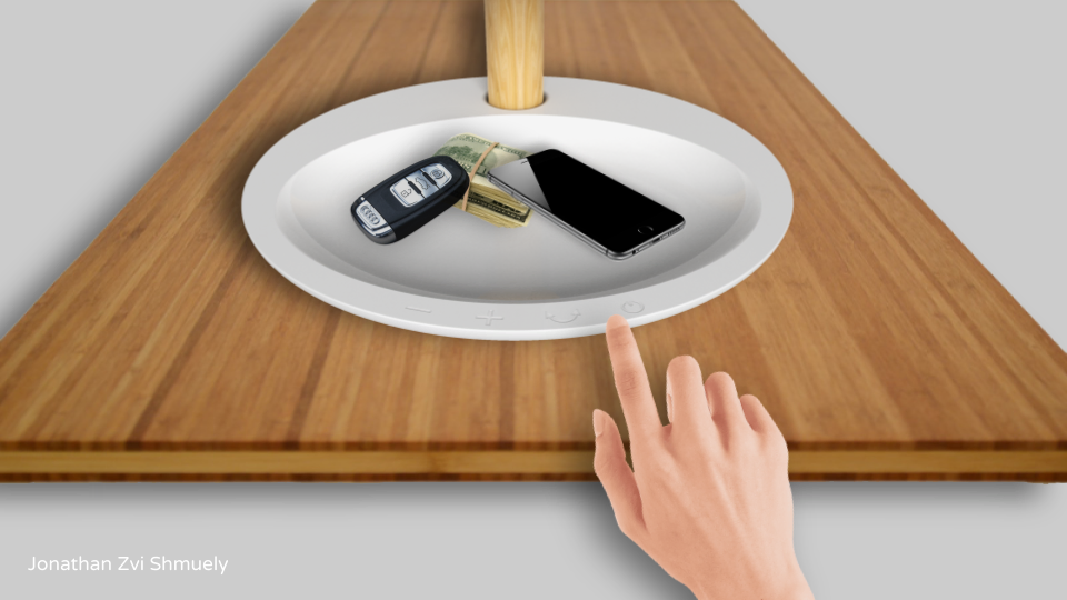 Hand touching the buttons on the FFU tray holding keys and a phone