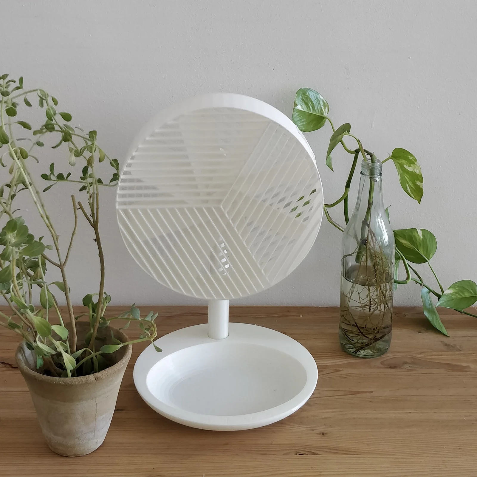 FFU fan prototype on a shelf next to plants and a bottle